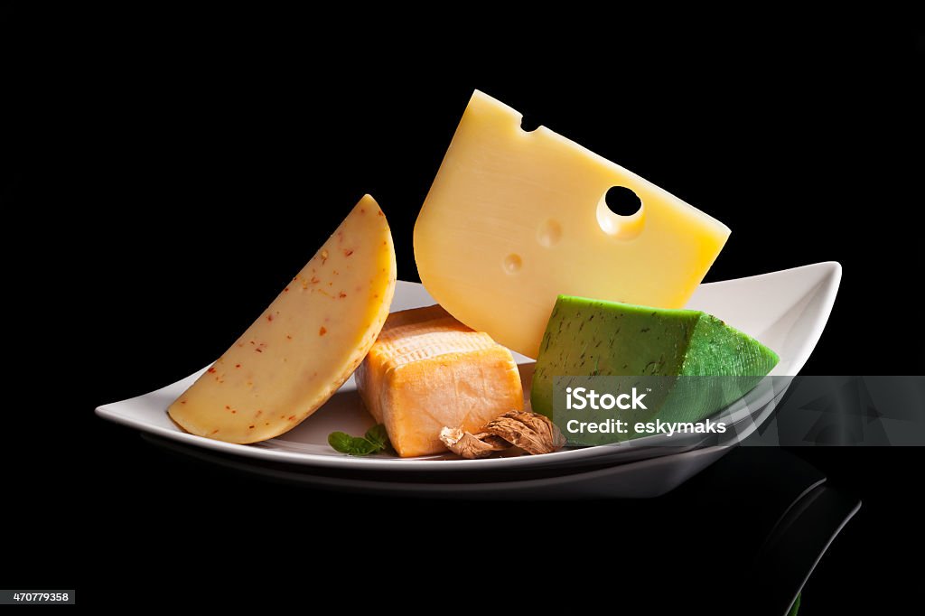 Culinary cheese variation. Colorful culinary cheese variation on black background. Gourmet cheese eating, modern minimal contemporary style. 2015 Stock Photo