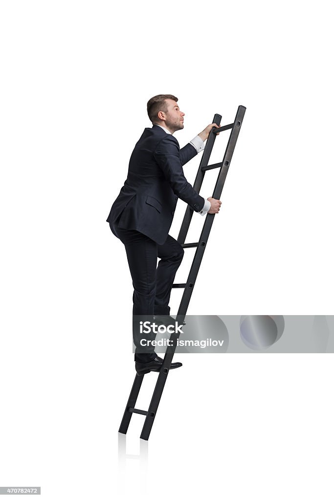 businessman is climbing to the career ladder Young businessman is climbing to the career ladder. Isolated. Ladder Stock Photo