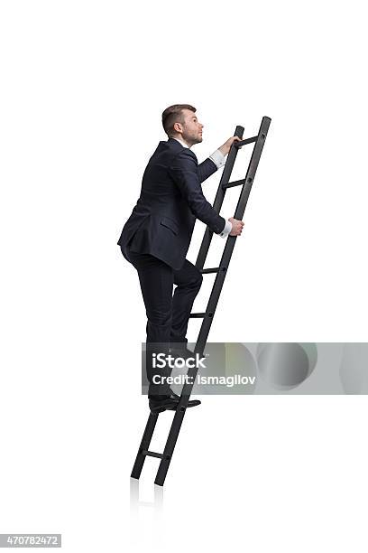 Businessman Is Climbing To The Career Ladder Stock Photo - Download Image Now - Ladder, Men, Moving Up