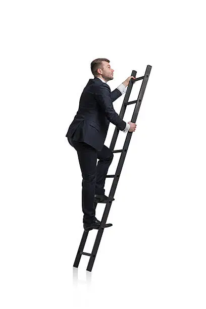 Young businessman is climbing to the career ladder. Isolated.