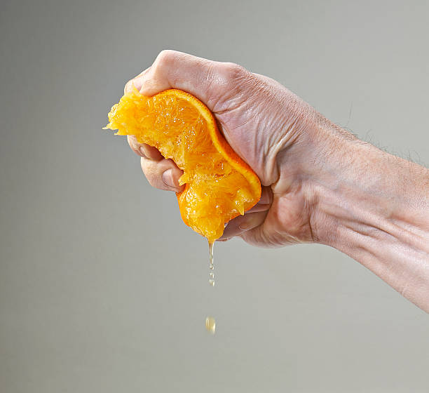 Fresh Squeezed Orange Juice by Male Hand