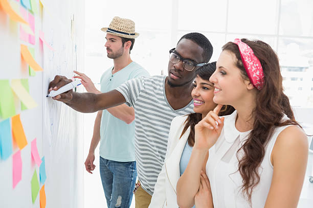 istock Smiling coworkers speaking and brainstorming 470784108