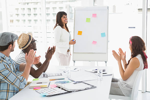 istock Smiling businessman and colleagues applauding 470784144