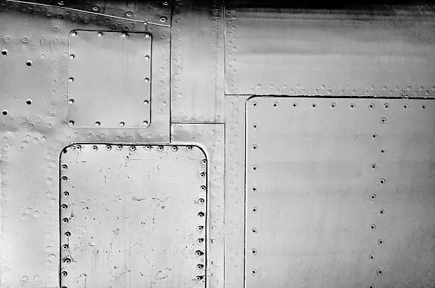 Close-up gray painted airplane metal panel background texture, rivets, dots, line