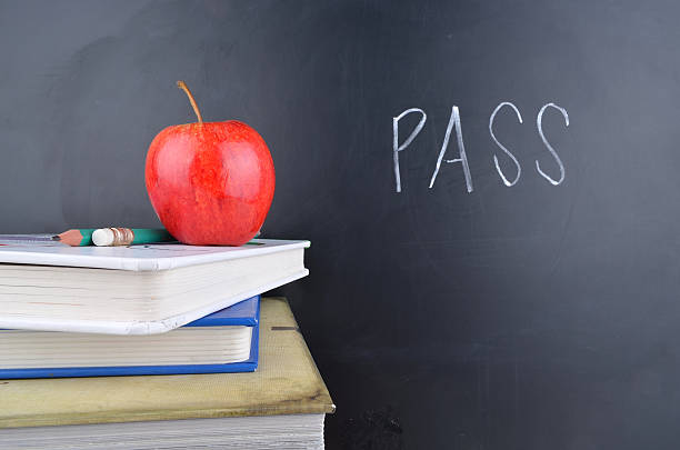 istock Classroom concept with books an apple and blackboard with handwriting 470787932
