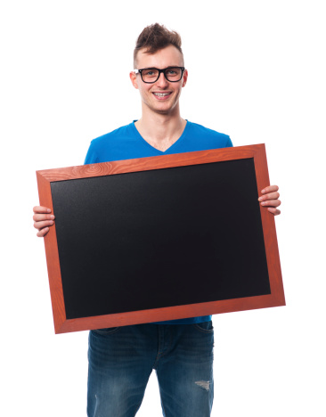 Smiling man holding empty blackboard