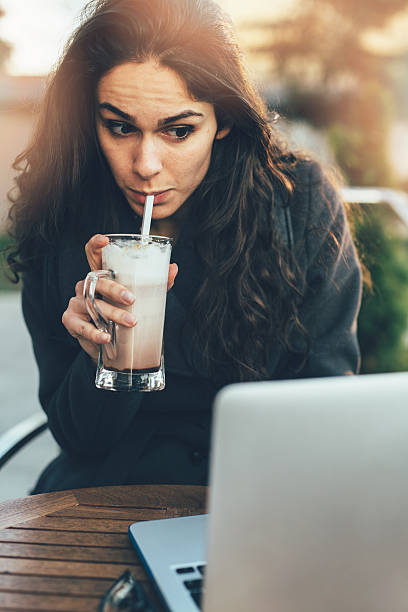istock Young lady browsing the Internet at the cafe 470792660