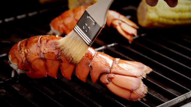 Delicious Lobster Tails and Sweetcorn on BBQ Grill