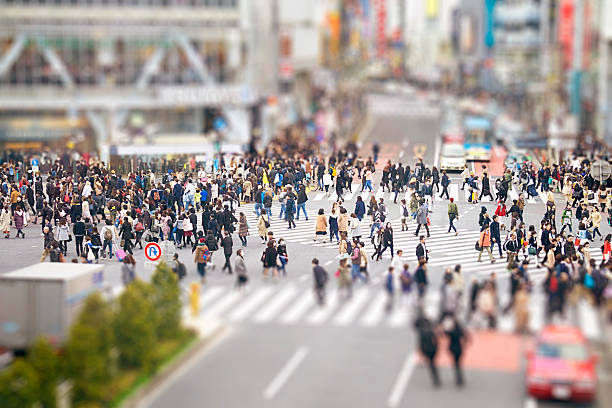 istock Crowd of people walking through busy city 470794922