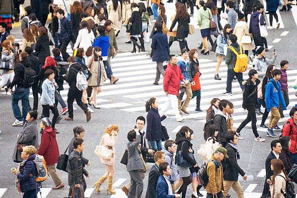 istock Crowd of people walking through busy city 470794928