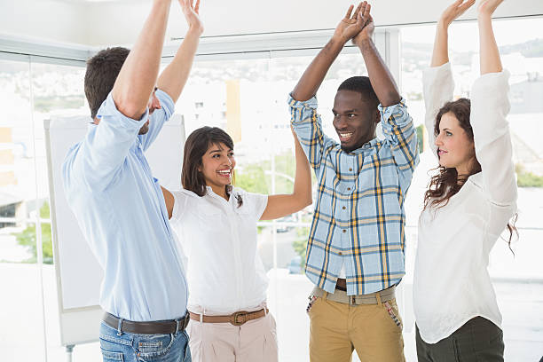 istock Happy coworkers standing and cheering together 470796786