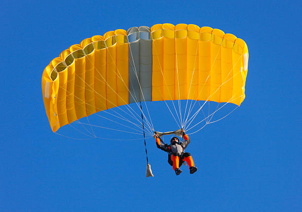 Parachute on a clear blue sky  Skydaiver parachuting stock pictures, royalty-free photos & images