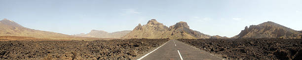istock Driving on an empty road towards the mountains 470797462