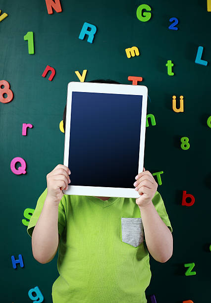 Boy with tablet Boy with tablet number magnet stock pictures, royalty-free photos & images
