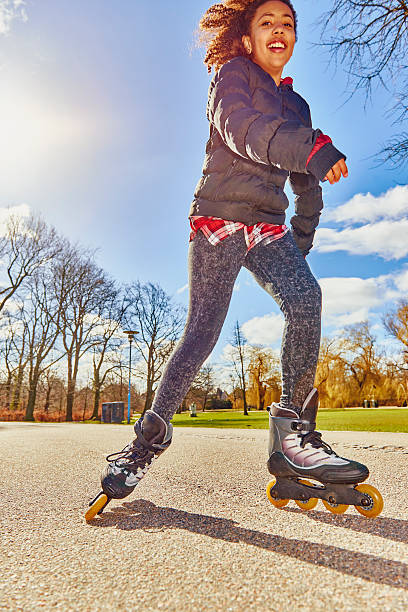 istock Roller skating teenage girl in park - sunlight backlit 470797746