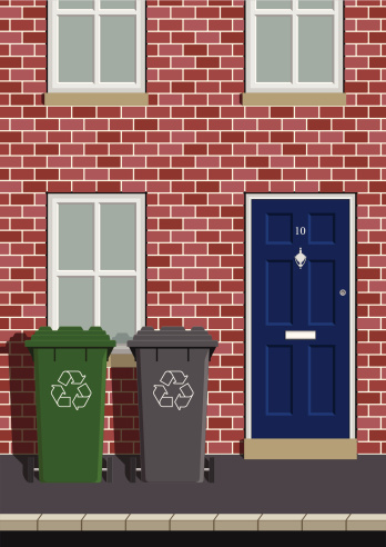 House on street with recycling wheelie bins