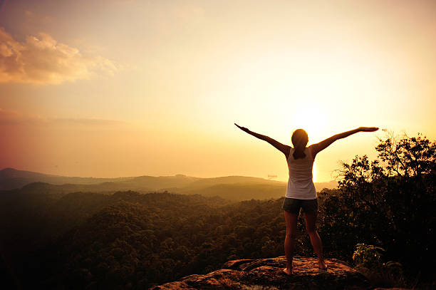 istock cheering hiking woman on mountain peak 470800338