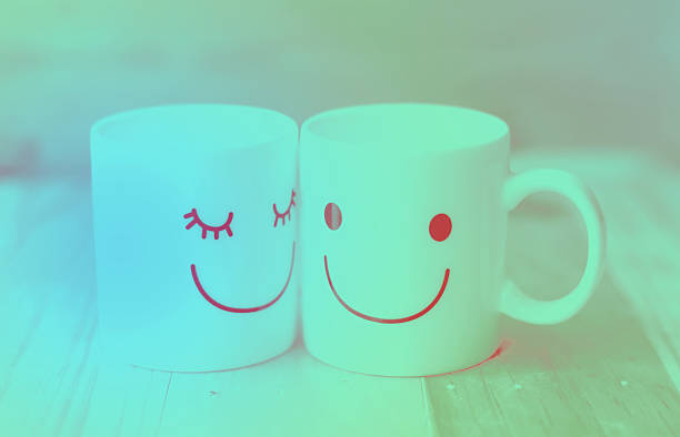 istock Two happy cups on wood table with bokeh, love concept 470801642