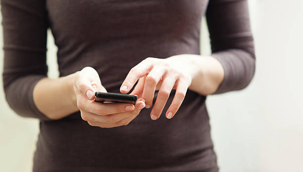 istock Close up of a woman using mobile smart phone 470802908
