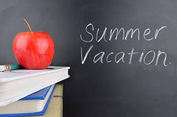 istock Classroom concept with books an apple and blackboard with handwriting 470803318