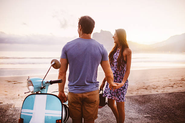 istock Loving couple at the beach with their scooter 470803324