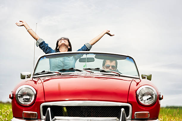 istock Happy young people in a cabriolet 470804471