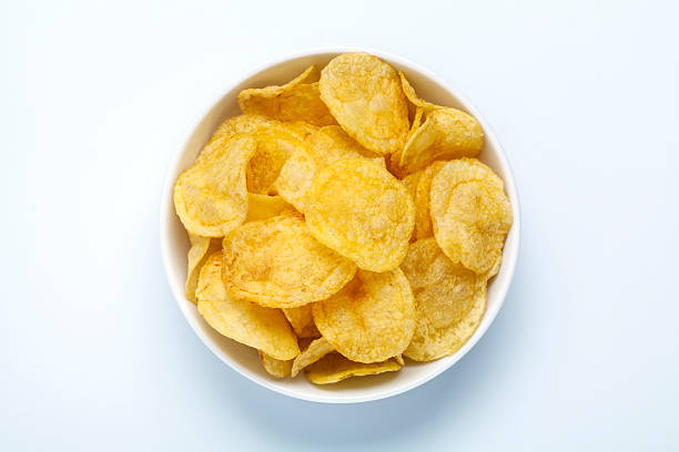 potato chips in a bowl top view of potato chips in a bowl potato chip stock pictures, royalty-free photos & images