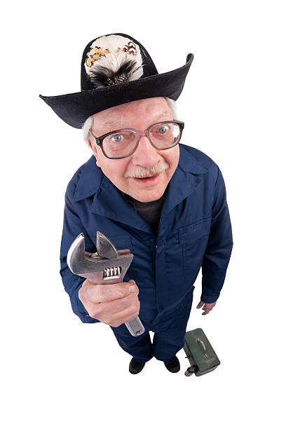 A fisheye image of a friendly redneck handyman holding a wrench with his toolbox by his side.