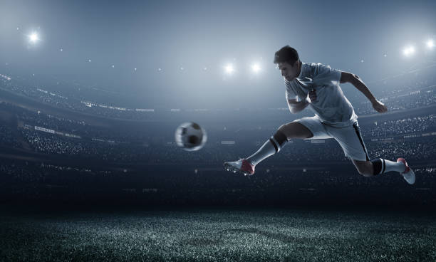 istock Soccer player kicking ball in stadium 470808016