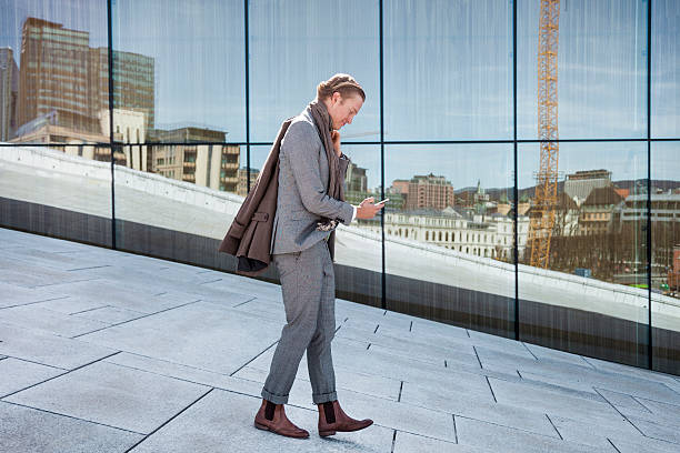 istock Businessman texting against office windows 470808228