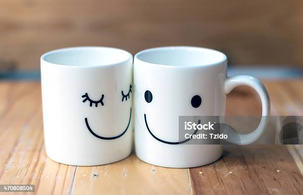 Two Happy Cups On Wood Table With Bokeh Love Concept Stock Photo - Download Image Now