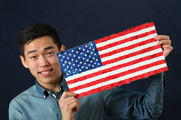 istock Young Asian student showing US national flag 470808740
