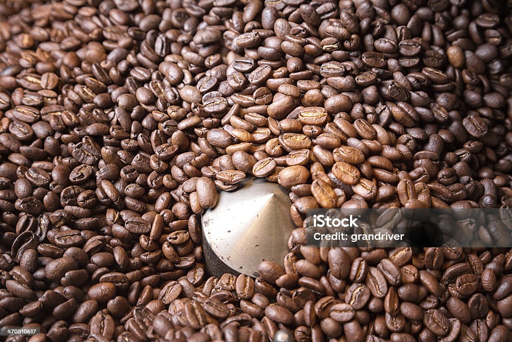 Fresh Roasted Coffee Beans Fresh roasted coffee beans from a commercial roaster in the cooling rack Automated Stock Photo