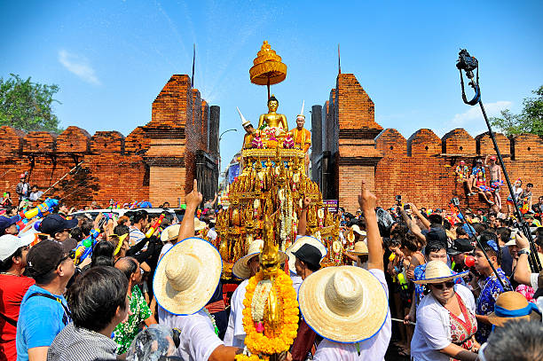 Songkran festival Chiang Mai, Thailand - April 13, 2015 : Chiang Mai Songkran festival, Unidentified men and women walking tradition of bathing the Buddha Phra Singh marched on an annual basis on Phra-Singh temple. with respect to faith during the annual festival. chiang mai province stock pictures, royalty-free photos & images