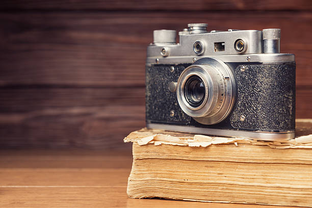 istock Vintage 35mm film camera on old book 470811968