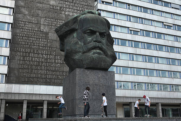 Chemnitz, Germany - May 8, 2012: Skateboarders training in front of the Karl Marx Monument by Soviet sculptor Lev Kerbel in Chemnitz, Saxony, Germany.