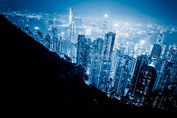 Hong Kong Cityscape skyscraper on two side of Victoria Harbour of Hong Kong. View from the Peak at night. central plaza hong kong stock pictures, royalty-free photos & images