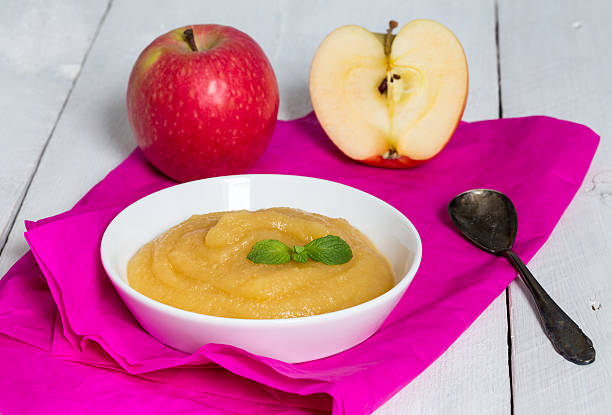 istock Applesauce on pink paper and spoon 470818326