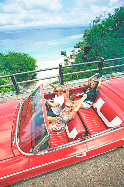 istock Happy young people in convertible car 470818516