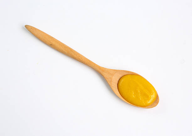 istock Vegetarian pumpkin soup in wooden spoon over white background 470819100
