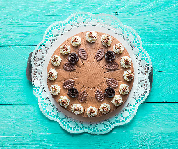 istock Chocolate cream cake on turquoise wood with cake lace 470823862
