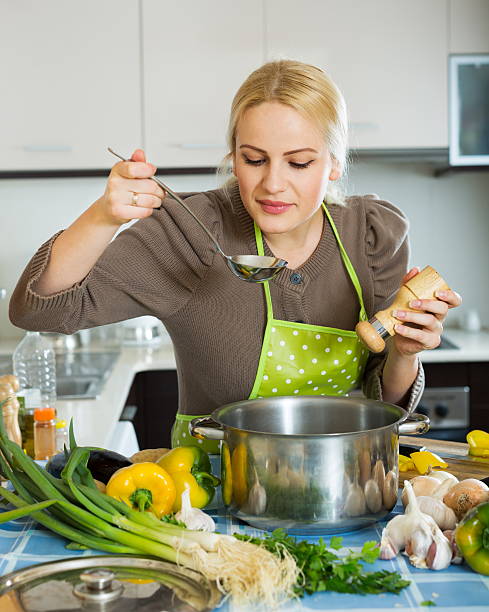 istock Joyful girl cooking with vegetables 470825296