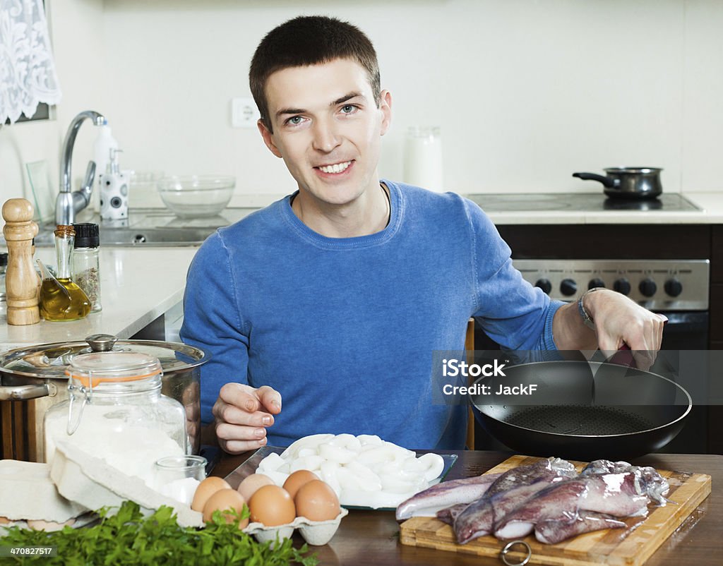 guy cooking guy cooking squid rings in batter Activity Stock Photo