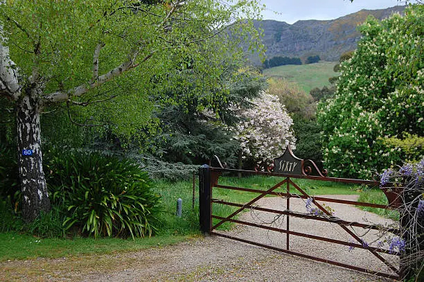 Entrance gate between trees, Banks Peninsula, Canterbury Region, New Zealand
