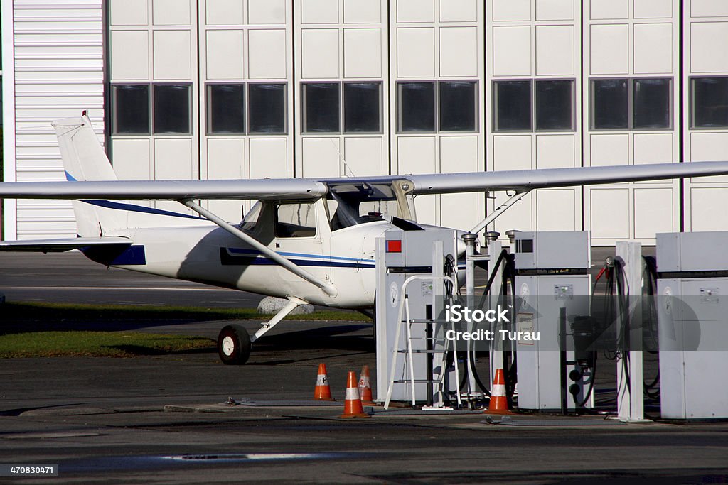 plane Airliner is between the hangar and the petrol station Adventure Stock Photo