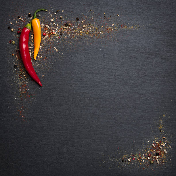 istock Chili peppers and spices on slate stone. 470830570