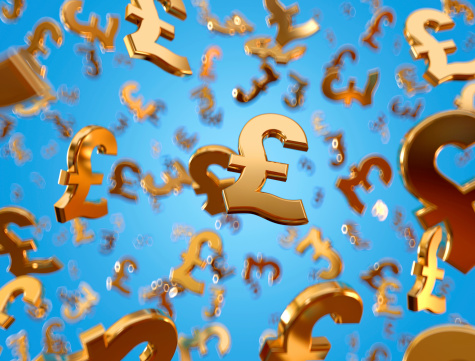 Golden pound sterling signs falling on the blue background.