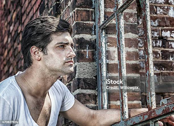 Young Man Looking Through Rusty Antique Window Frame Stock Photo - Download Image Now