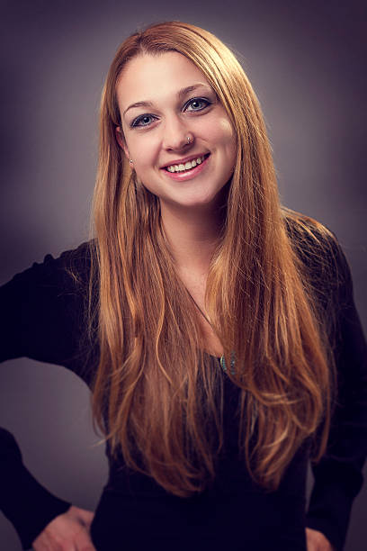 istock friendly young woman smiling at the camera 470833733