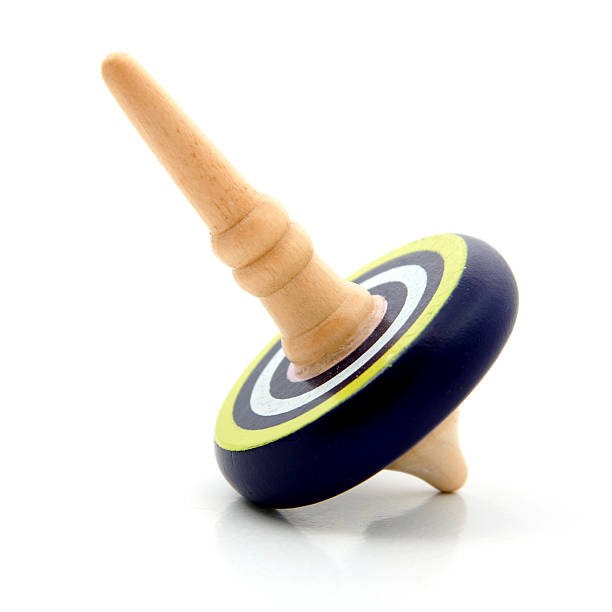 istock blue wooden Spinning top over white background 470835256